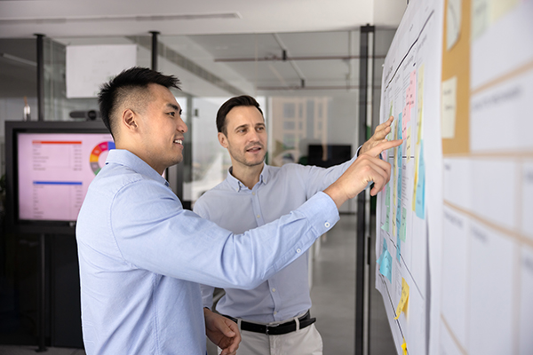 Two staff members in a business meeting carrying out financial modeling